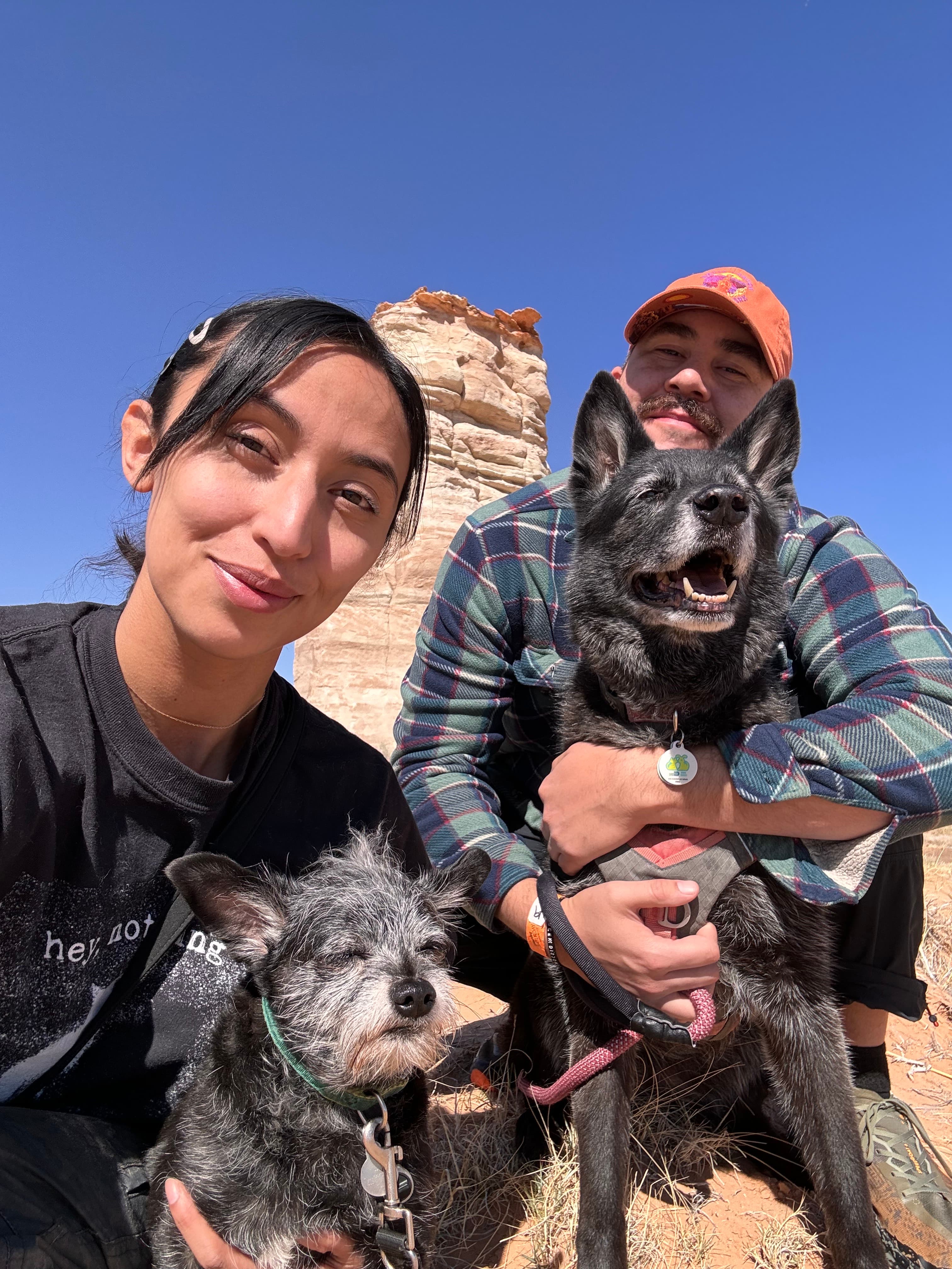 Michael and Ciara with their two dogs in a desert canyon landscape